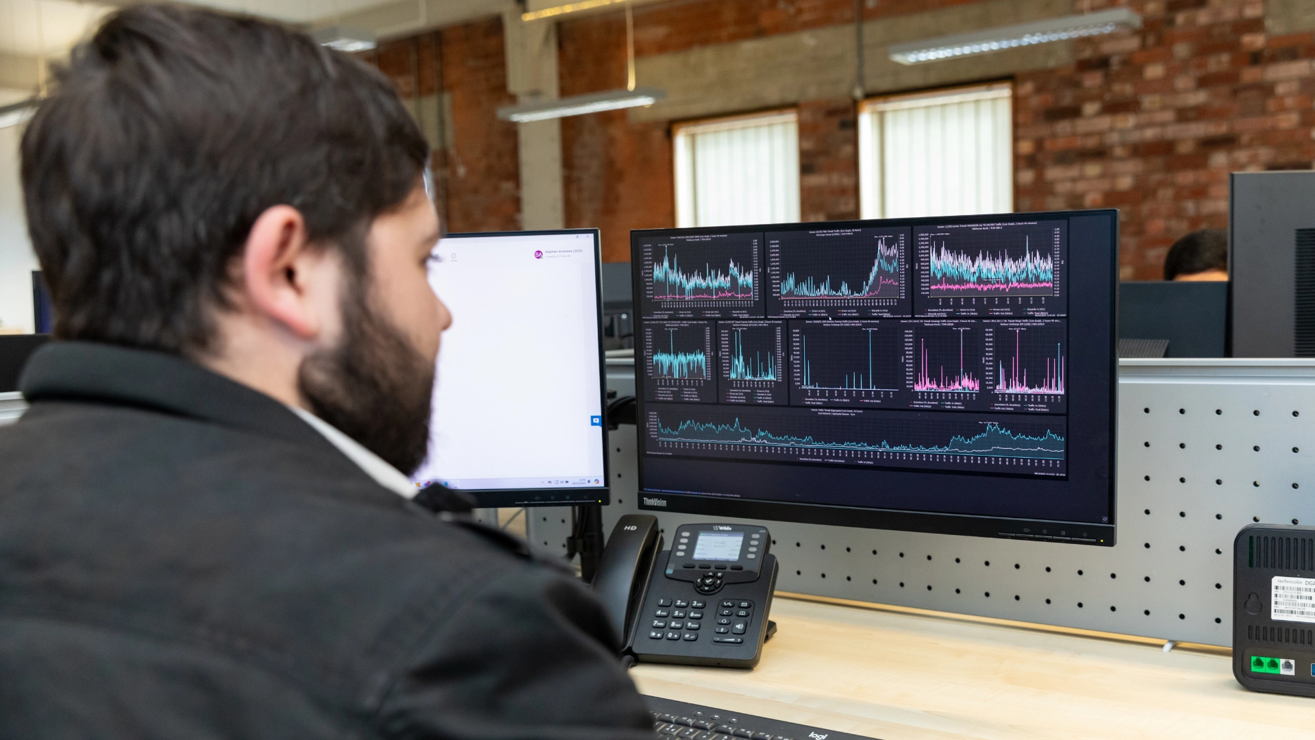 Syscom team member working on a computer helping with cybersecuirty